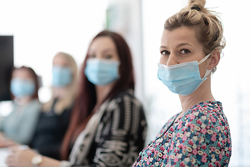 Image showing real business people on meeting wearing protective mask