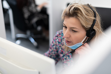 Image showing call center operator in medical mask