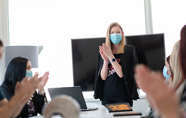 Image showing real business people on meeting wearing protective mask