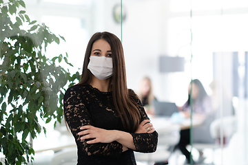 Image showing business woman portrait in medical protective mask