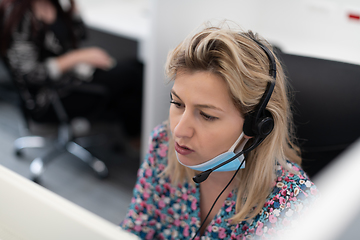 Image showing call center operator in medical mask