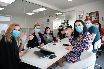 Image showing real business people on meeting wearing protective mask