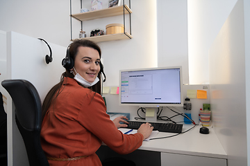 Image showing call center operator in medical mask