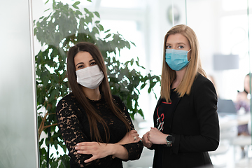 Image showing business team in protective medical mask at modern office