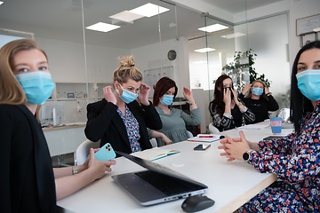 Image showing real business people on meeting wearing protective mask