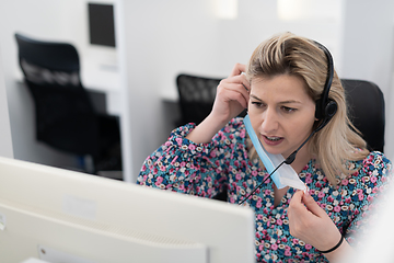 Image showing call center operator in medical mask