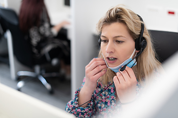 Image showing call center operator in medical mask