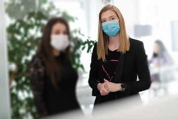 Image showing business team in protective medical mask at modern office