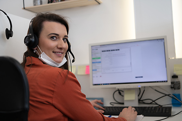 Image showing call center operator in medical mask