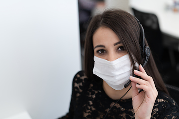 Image showing call center operator in medical mask