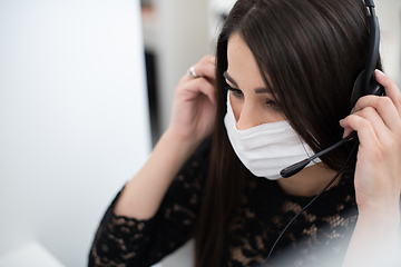 Image showing call center operator in medical mask