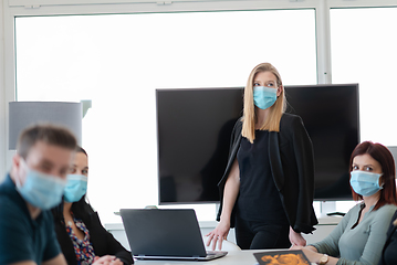 Image showing real business people on meeting wearing protective mask