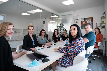 Image showing real business people on meeting wearing protective mask