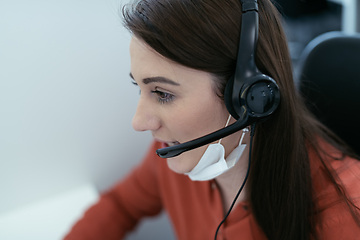 Image showing call center operator in medical mask