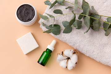 Image showing serum, clay mask, oil and eucalyptus on bath towel