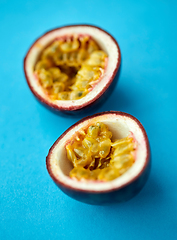 Image showing cut passion fruit on blue background