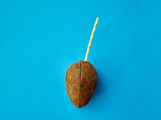 Image showing coconut drink with paper straw on blue background