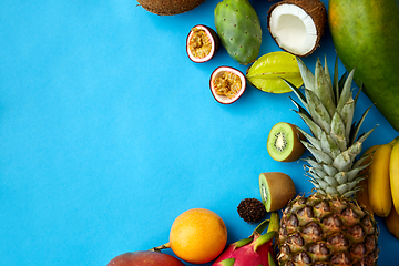 Image showing different exotic fruits on blue background