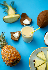 Image showing pineapple, coconut and drink with paper straw