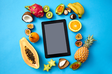 Image showing fruits around tablet computer on blue background