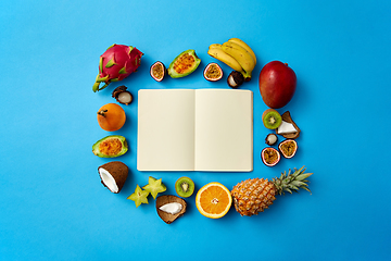 Image showing exotic fruits around notebook with empty pages