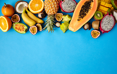 Image showing different exotic fruits on blue background