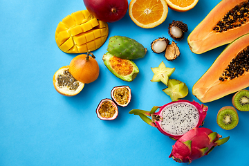 Image showing different exotic fruits on blue background