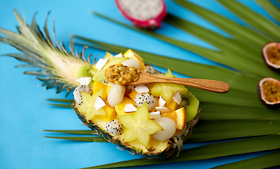 Image showing mix of exotic fruits in pineapple with spoon