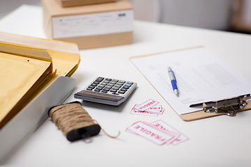 Image showing calculator, clipboard and envelopes at post office