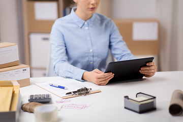 Image showing woman with tablet pc and clipboard at post office