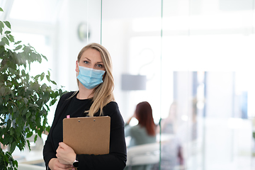 Image showing business woman portrait in medical protective mask