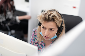 Image showing call center operator in medical mask