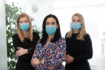 Image showing business team in protective medical mask at modern office