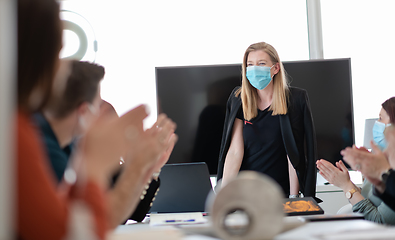 Image showing real business people on meeting wearing protective mask