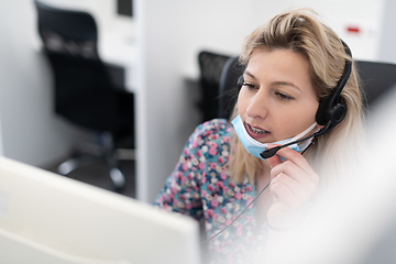 Image showing call center operator in medical mask