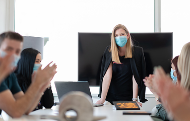 Image showing real business people on meeting wearing protective mask