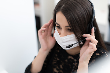 Image showing call center operator in medical mask