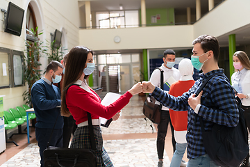 Image showing students greeting new normal coronavirus handshake and elbow bumping