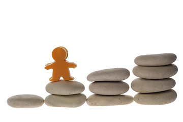 Image showing Figurine on stack of pebbles