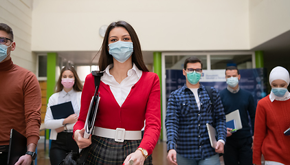 Image showing students group at university walking and wearing face mask