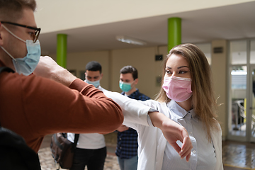 Image showing students greeting new normal coronavirus handshake and elbow bumping