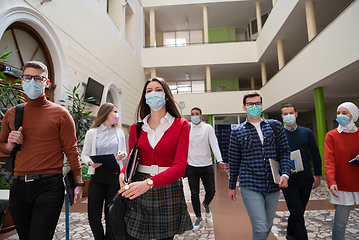 Image showing students group at university walking and wearing face mask