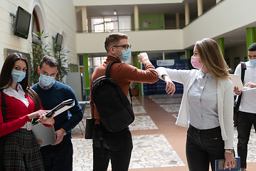 Image showing students greeting new normal coronavirus handshake and elbow bumping