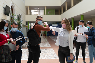 Image showing students greeting new normal coronavirus handshake and elbow bumping