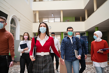 Image showing students group at university walking and wearing face mask