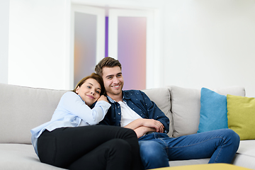 Image showing young couple watching tv at home in bright living room