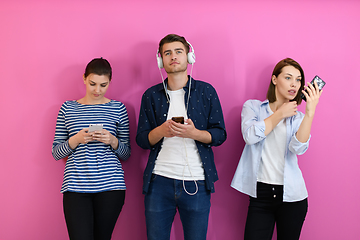 Image showing group of friends have fun and dance while using a cell phone and headphones