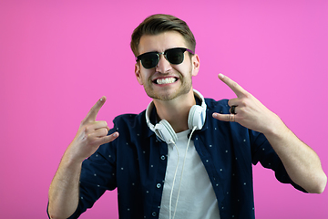Image showing guy wears glasses and headphones while dancing and having fun