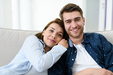 Image showing young couple watching tv at home in bright living room