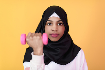 Image showing afro muslim woman promotes a healthy life, holding dumbbells in her hands